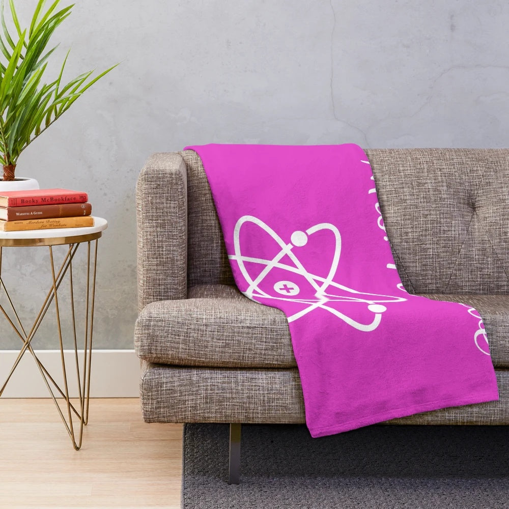 Plush blanket with atom design, science-themed home decor