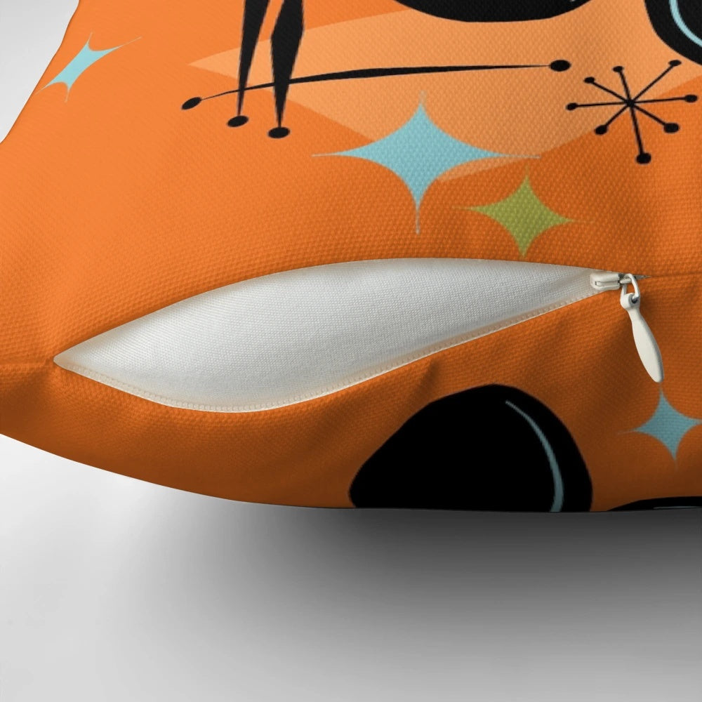 Vibrant orange, black, and white cat trio pillow in a retro, atomic age style design
