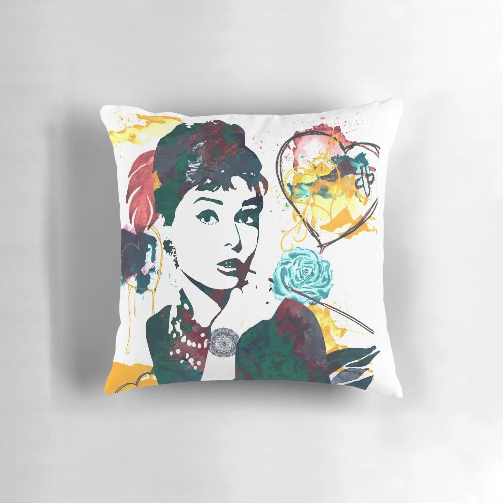 Decorative throw pillow featuring a nature-inspired color palette and Audrey Hepburn's iconic portrait