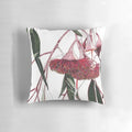 Vibrant pink and green eucalyptus flowering gum illustration on a decorative pillow.