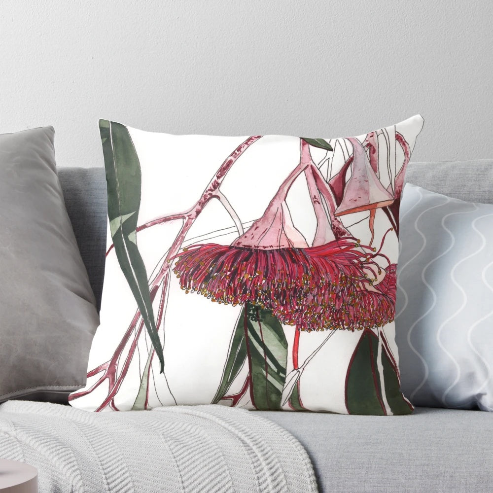 Vibrant pink and green eucalyptus flowering gum illustration on a decorative pillow.