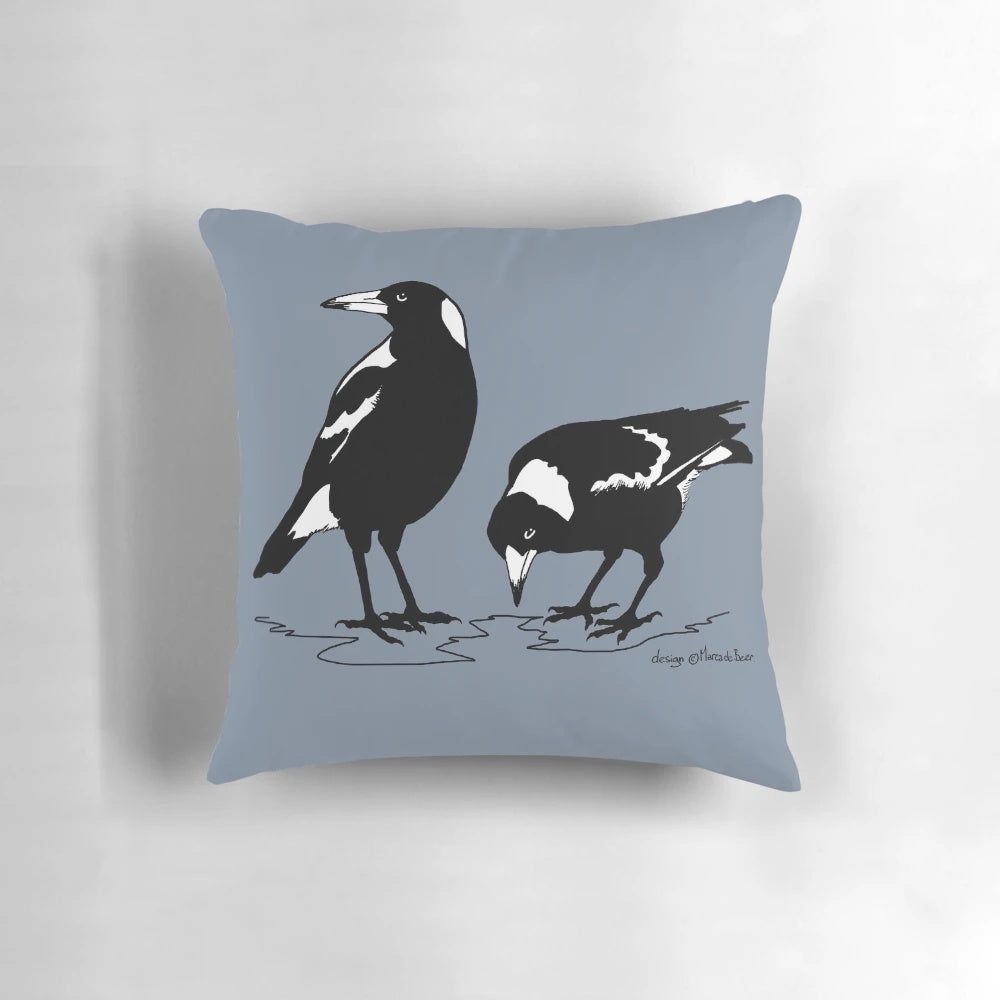 Stylish black and white graphic art illustration of an Australian magpie on a decorative throw pillow.