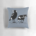 Stylish black and white graphic art illustration of an Australian magpie on a decorative throw pillow.