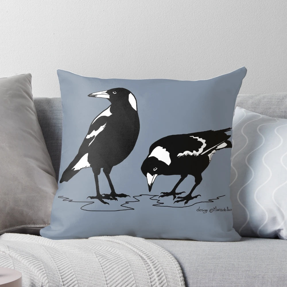 Stylish black and white graphic art illustration of an Australian magpie on a decorative throw pillow.
