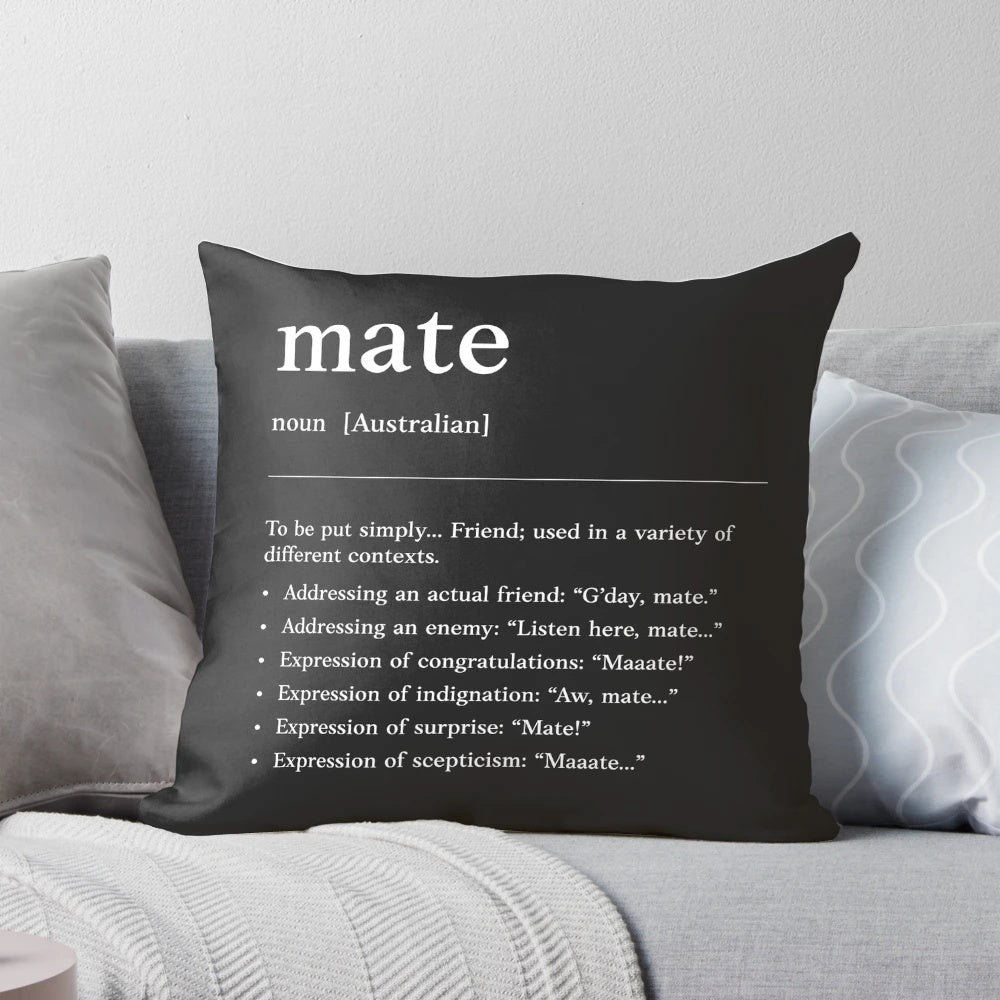 White on black pillow with the Australian slang term "mate" printed on it.