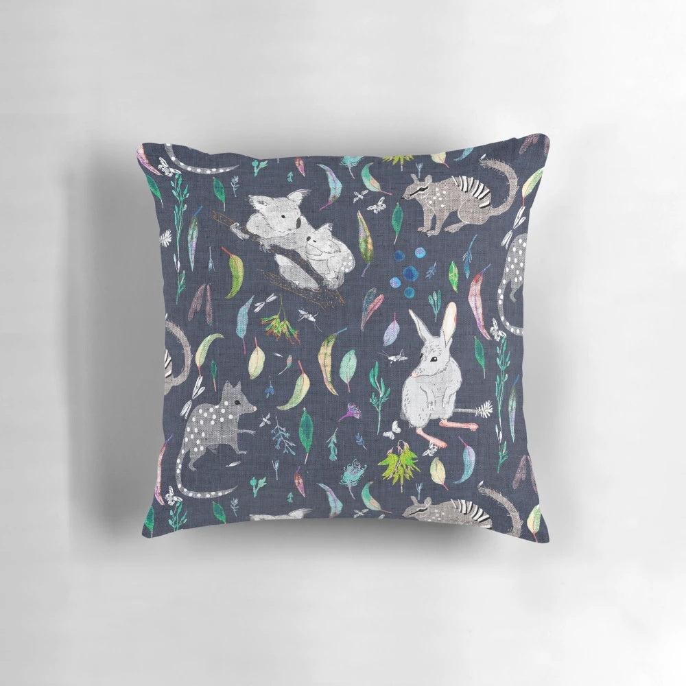 Australiana Marsupial Decorative Pillow featuring koalas, bilbies, and quolls on a navy background with gum leaves and nuts