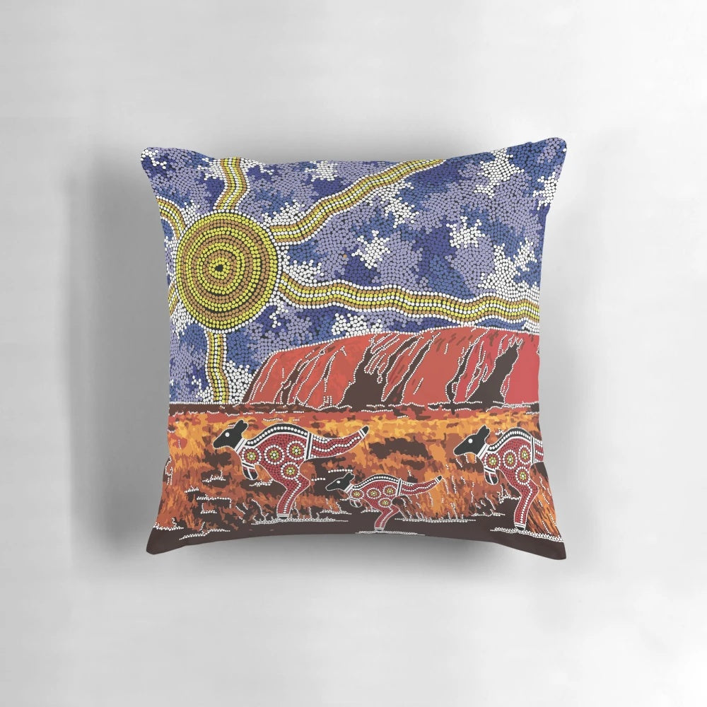 Pillow featuring vibrant aboriginal art design inspired by the iconic Uluru rock formation in the Australian outback.