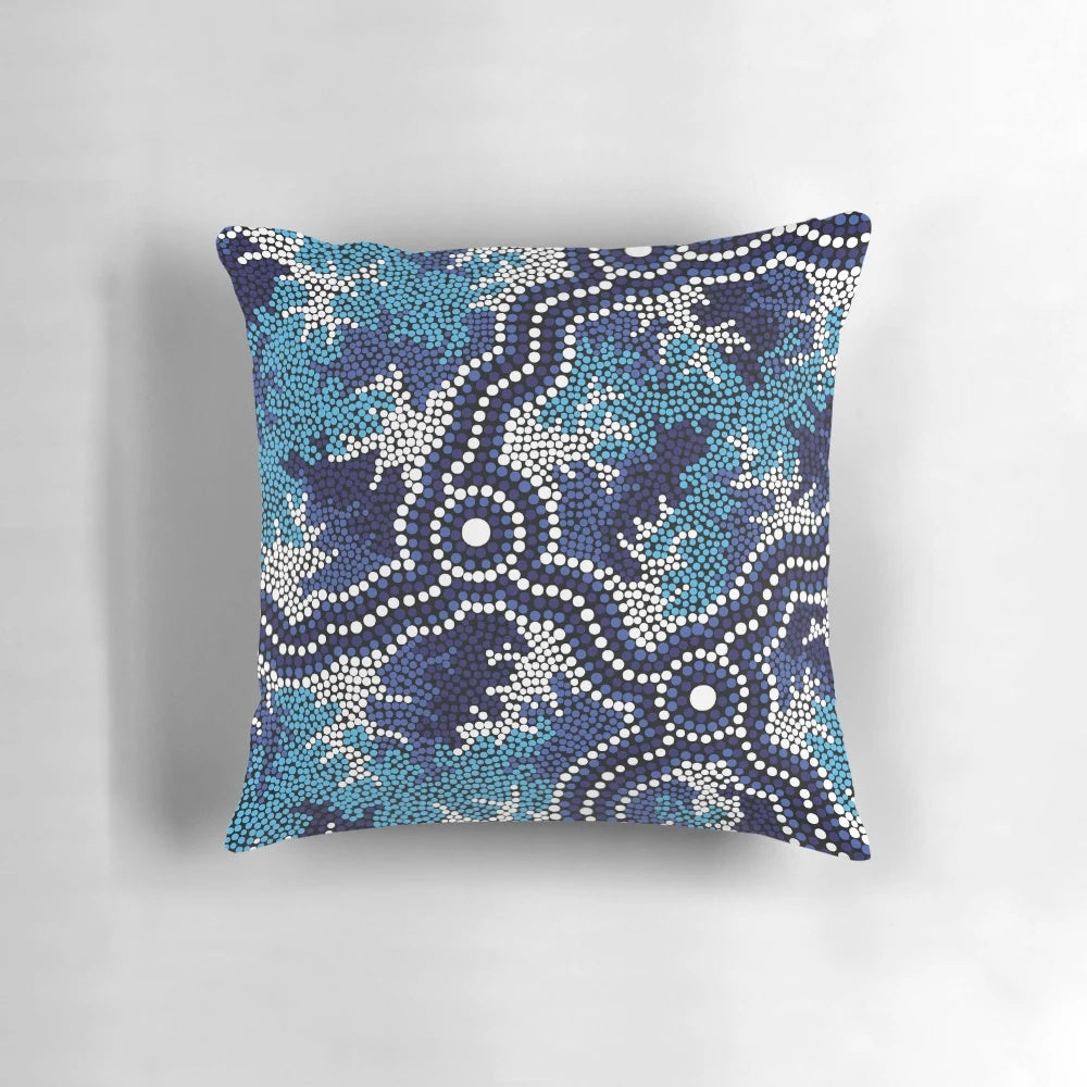 Vibrant blue aboriginal art pillow featuring traditional indigenous dot patterns and Australian wildlife like kangaroos and emus.