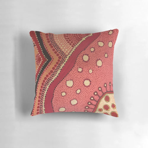 Colorful aboriginal dot art design on a pink and white pillow