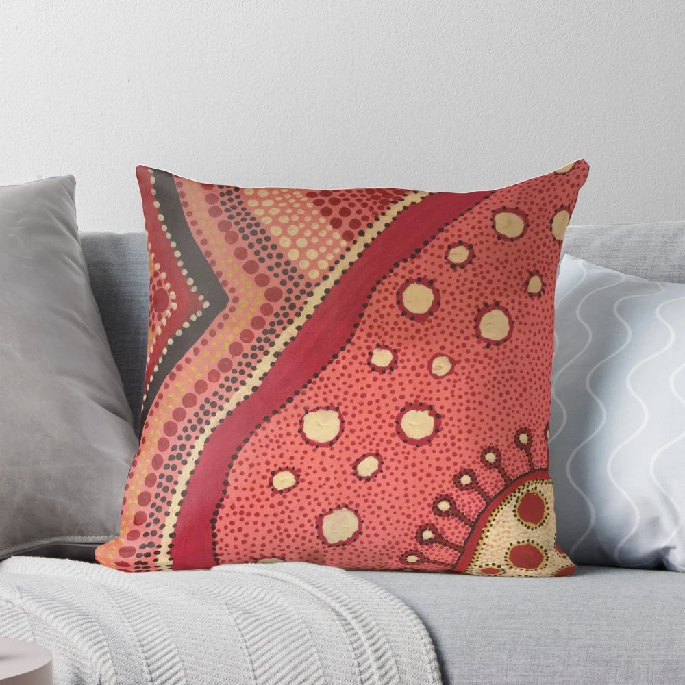 Colorful aboriginal dot art design on a pink and white pillow