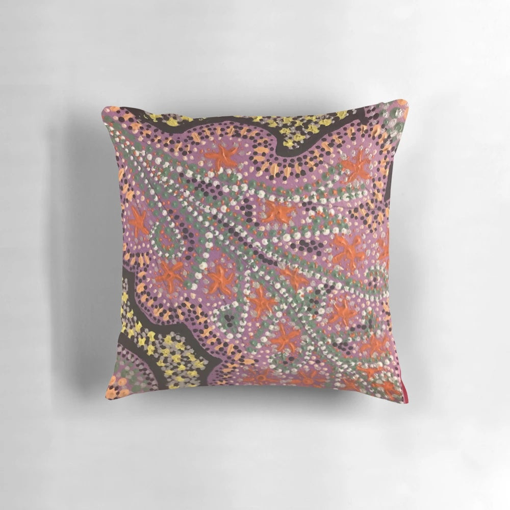 Vibrant pink aboriginal dot art pattern on a decorative pillow
