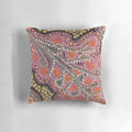 Vibrant pink aboriginal dot art pattern on a decorative pillow