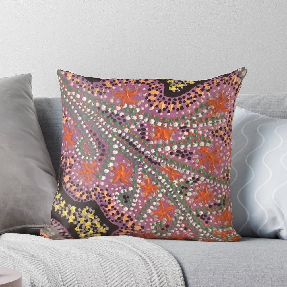 Vibrant pink aboriginal dot art pattern on a decorative pillow
