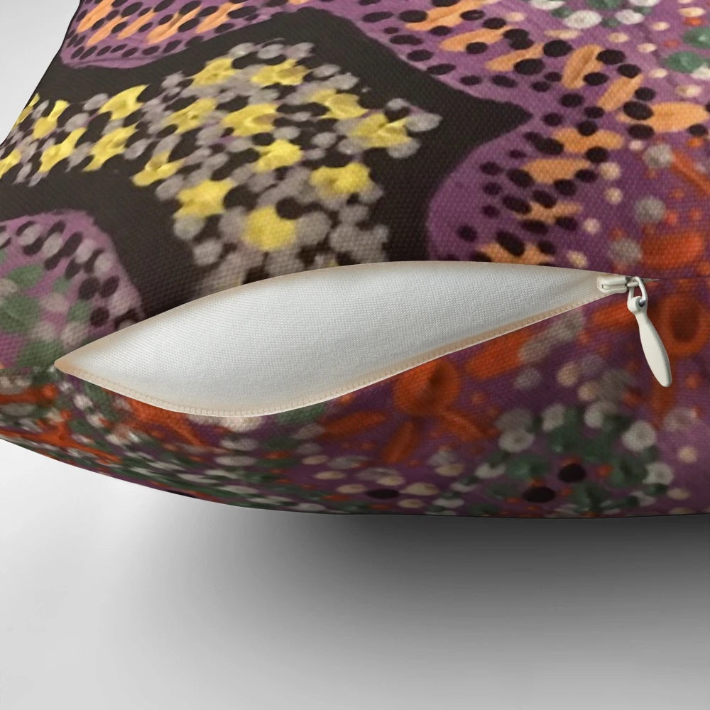 Vibrant pink aboriginal dot art pattern on a decorative pillow