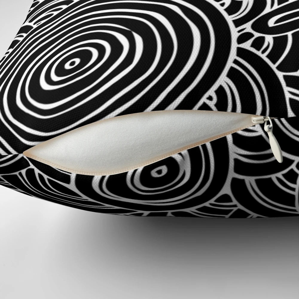 Patterned black and white pillow featuring aboriginal-inspired dot art and symbols