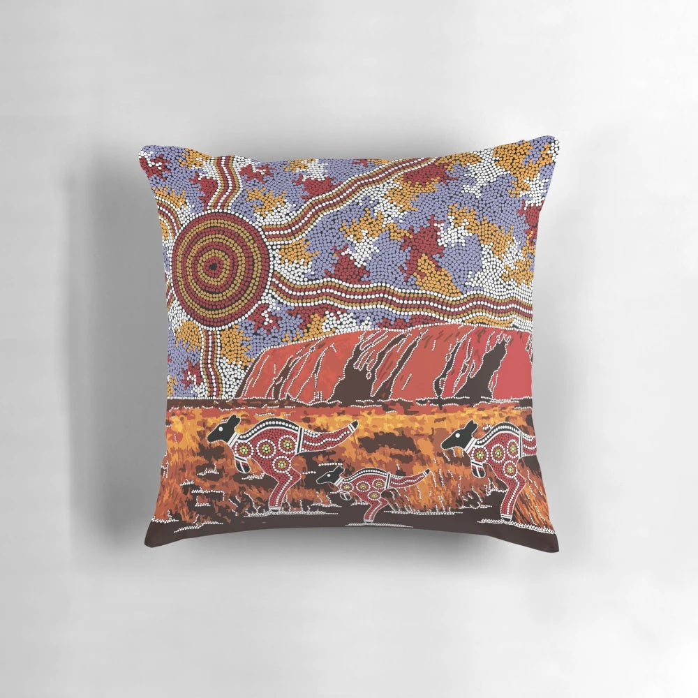 Pillow featuring a landscape design inspired by the iconic Uluru rock formation in the Australian outback, with aboriginal dot art elements.