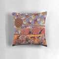 Pillow featuring a landscape design inspired by the iconic Uluru rock formation in the Australian outback, with aboriginal dot art elements.