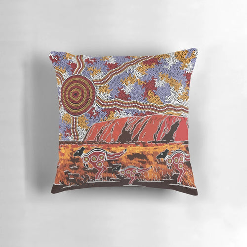 Pillow featuring a landscape design inspired by the iconic Uluru rock formation in the Australian outback, with aboriginal dot art elements.