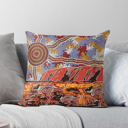 Pillow featuring a landscape design inspired by the iconic Uluru rock formation in the Australian outback, with aboriginal dot art elements.