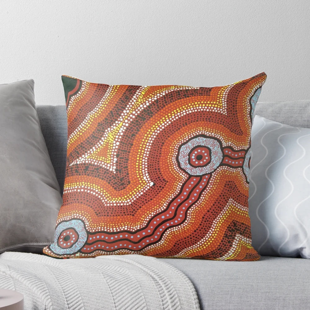 Vibrant acrylic painting of an Australian aboriginal waterhole scene on a decorative throw pillow