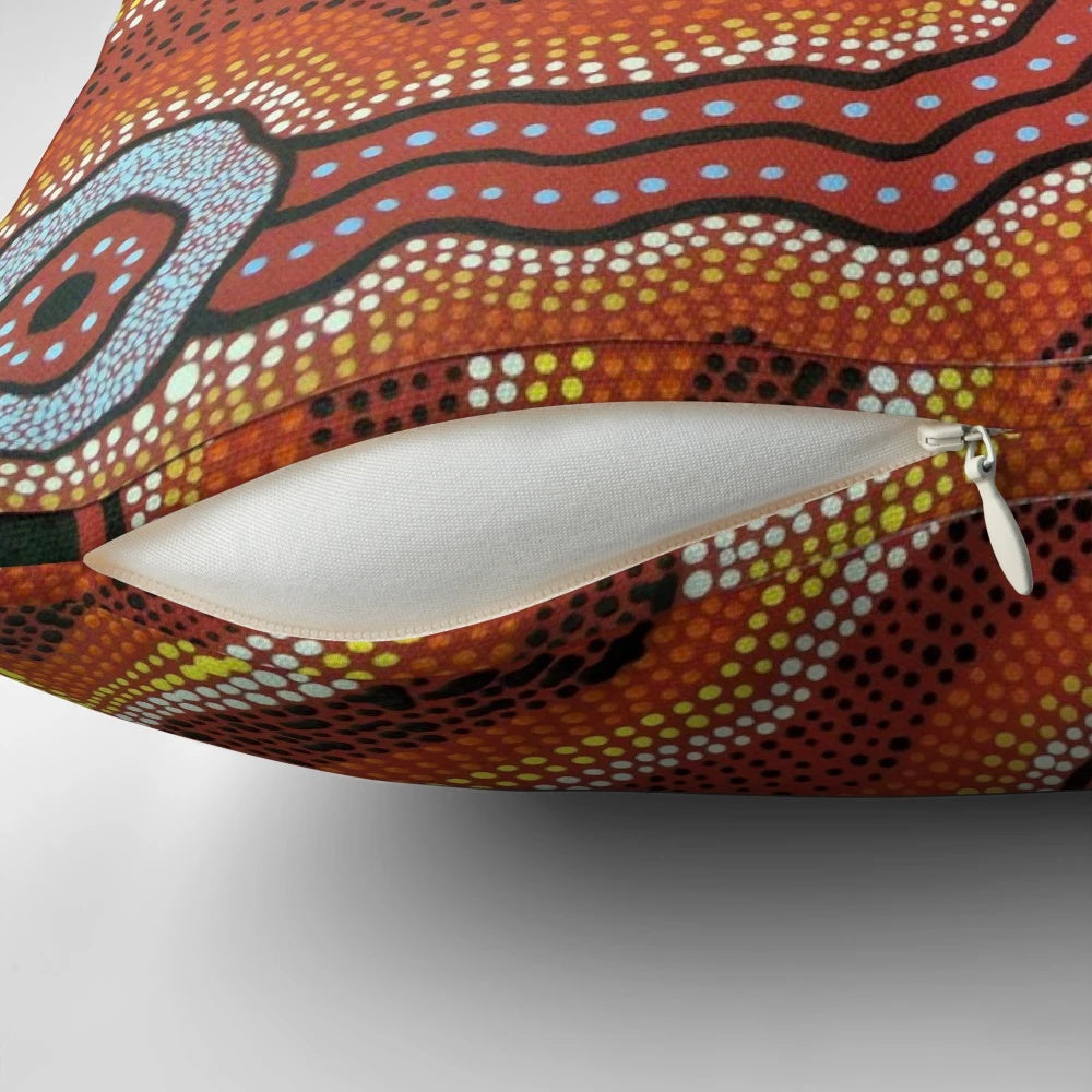 Vibrant acrylic painting of an Australian aboriginal waterhole scene on a decorative throw pillow