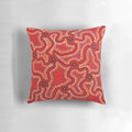Vibrant aboriginal dot painting artwork on a comfortable throw pillow