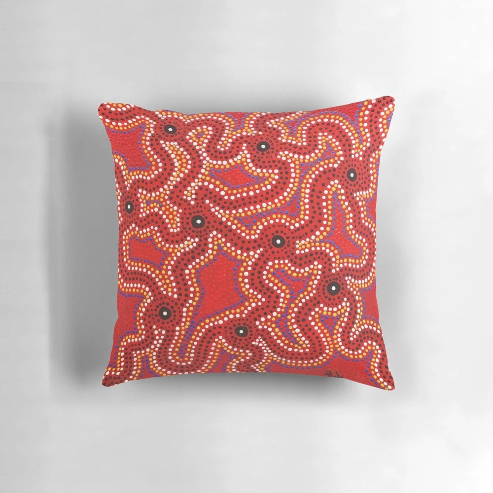 Vibrant aboriginal dot painting artwork on a comfortable throw pillow