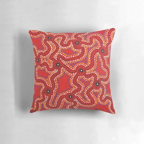 Vibrant aboriginal dot painting artwork on a comfortable throw pillow