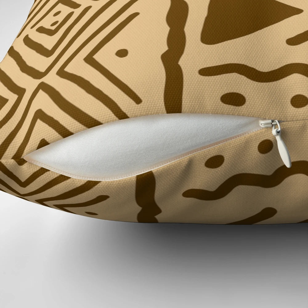 Tan and brown African Bogolan design throw pillow with tribal patterns for boho and safari-inspired home decor.