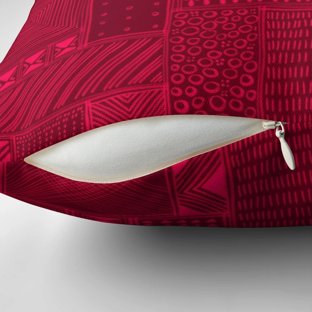 A vibrant red and black tribal-inspired mud cloth design decorative pillow for African-themed home decor.
