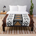 Soft, plush blanket with authentic African tribal bogolan pattern