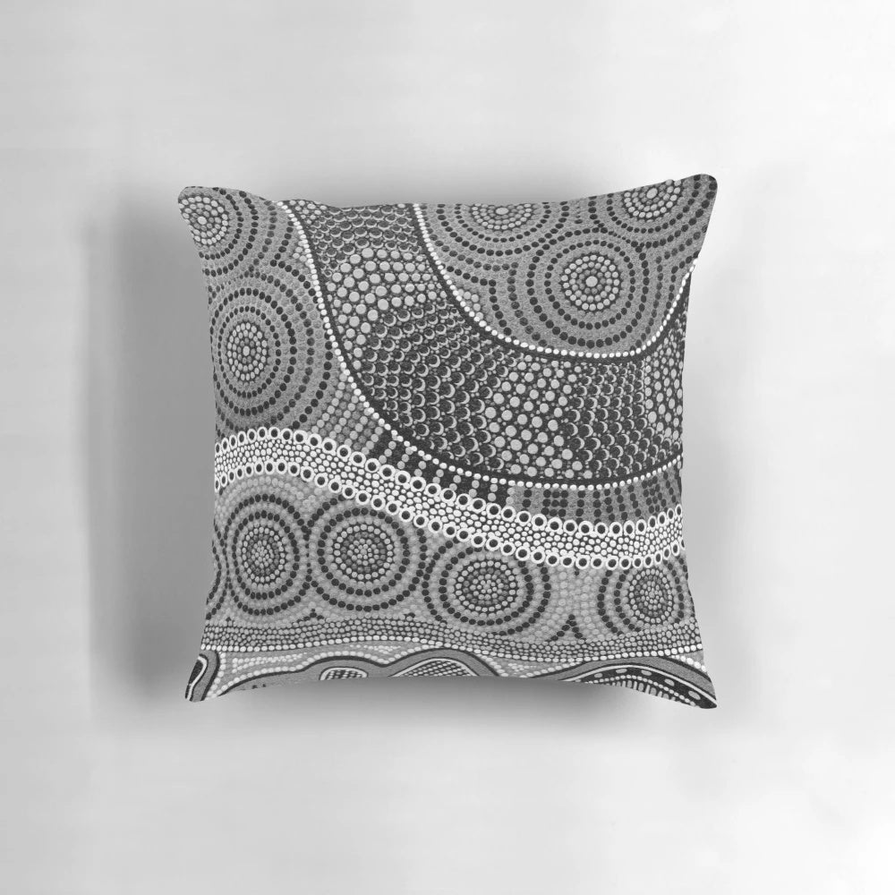 Vibrant aboriginal dot painting design on a soft, decorative throw pillow