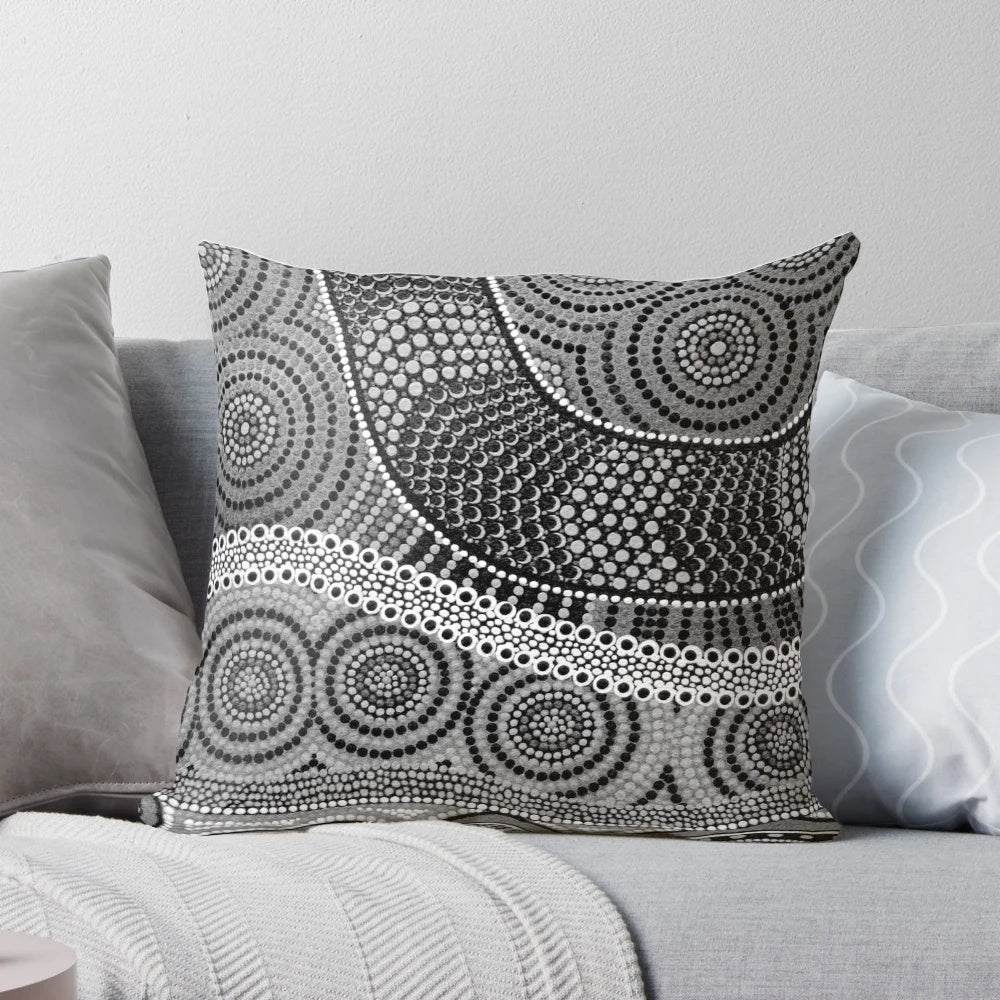 Vibrant aboriginal dot painting design on a soft, decorative throw pillow