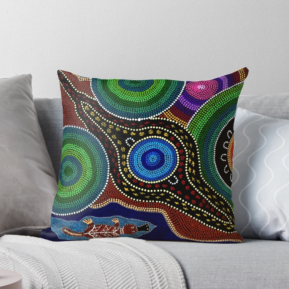 Colorful Australian aboriginal dot painting style design featuring a playful platypus on a soft, comfortable pillow.
