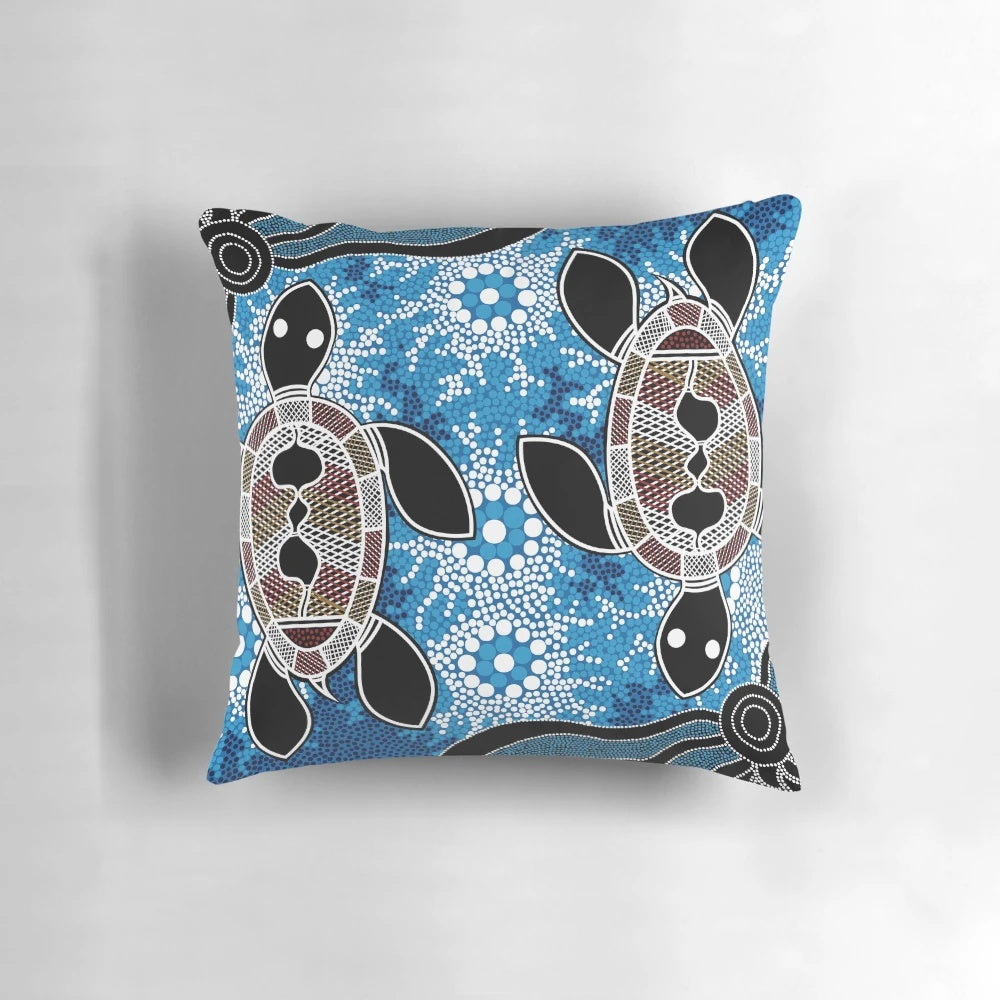 Vibrant blue and ochre aboriginal dot art sea turtles pattern on a throw pillow
