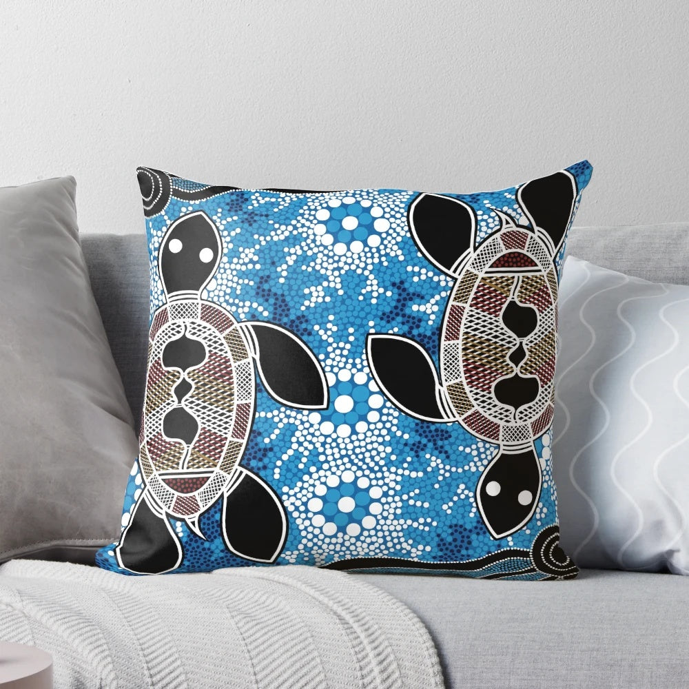 Vibrant blue and ochre aboriginal dot art sea turtles pattern on a throw pillow