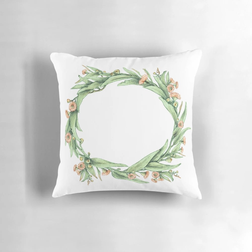 Eucalyptus wreath on a neutral-colored pillow, creating a natural and botanical home accent.