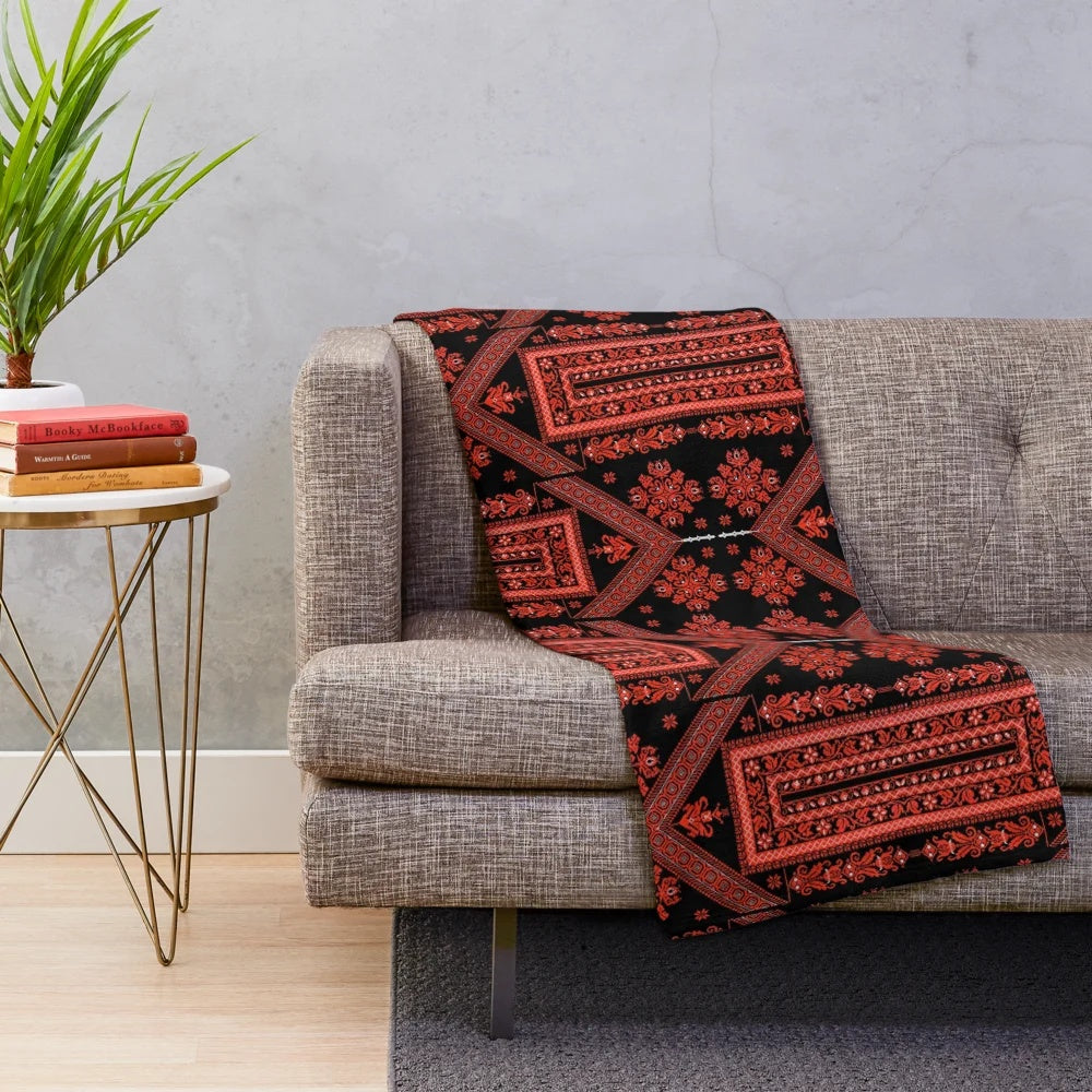 Palestinian embroidered plush blanket featuring traditional red and black designs