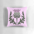 A Scottish thistle flower, the national flower of Scotland, on a pale pink pillow.
