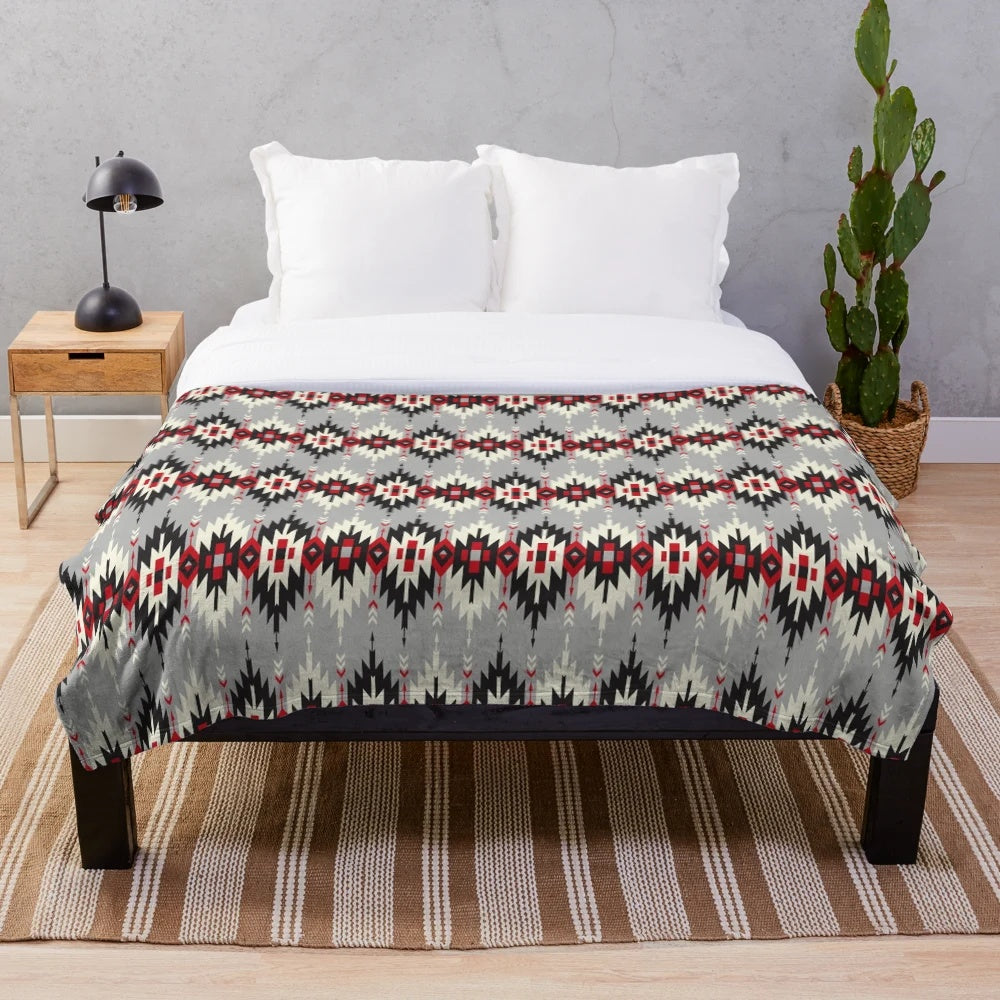 Plush blanket featuring native American-inspired artwork and designs