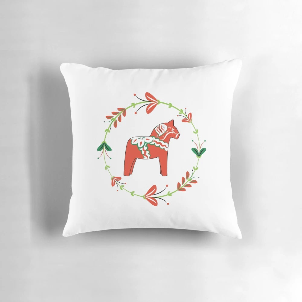 Dala horse pillow with traditional Swedish flower wreath design
