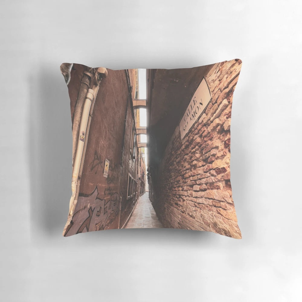 Cozy pillow with a scenic view of a narrow, winding street in the historic city of Venice, Italy