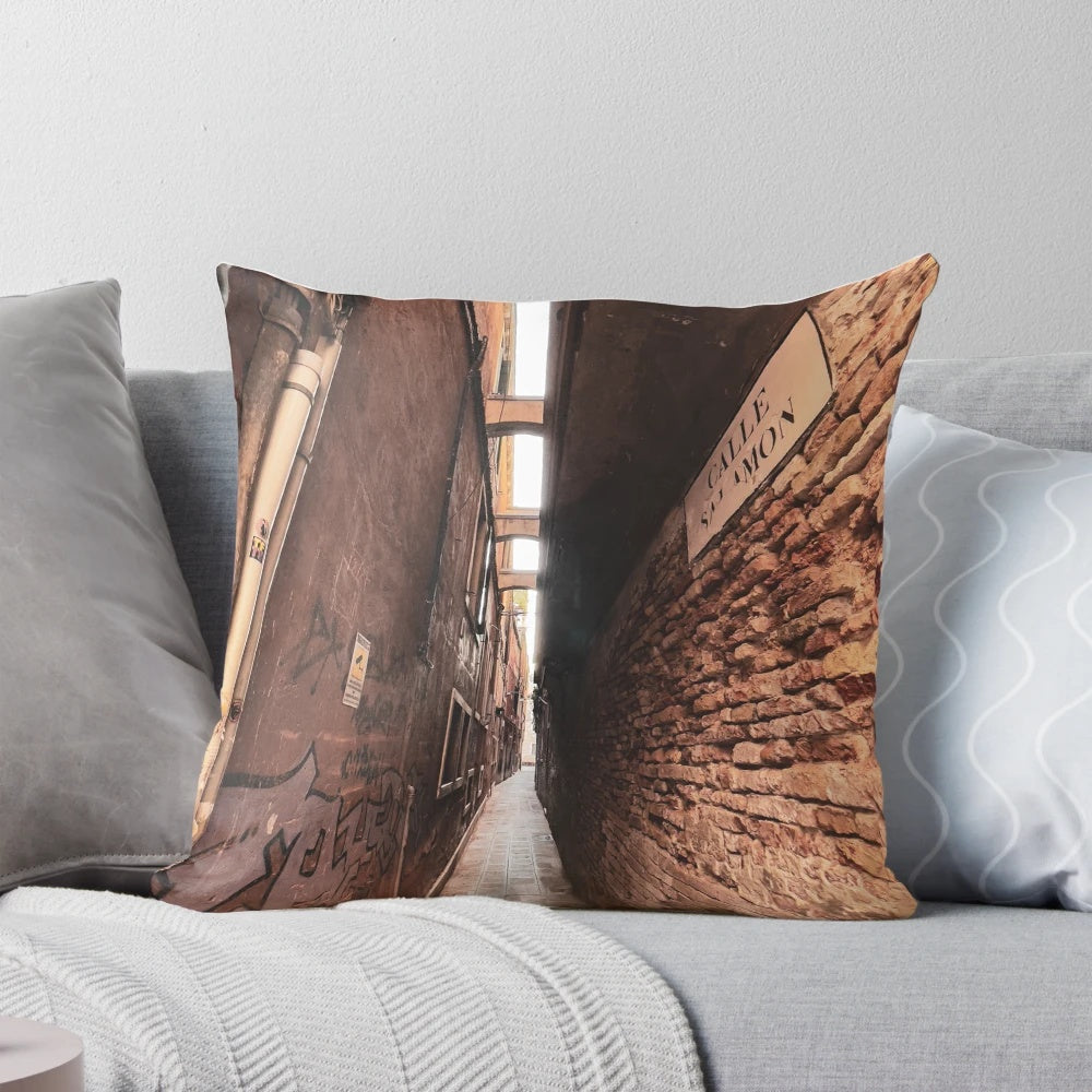 Cozy pillow with a scenic view of a narrow, winding street in the historic city of Venice, Italy