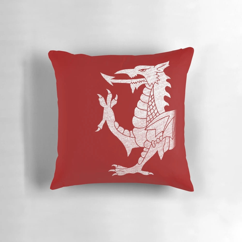 A white pillow with a vibrant Welsh dragon design, perfect for adding a touch of Welsh culture to your home.
