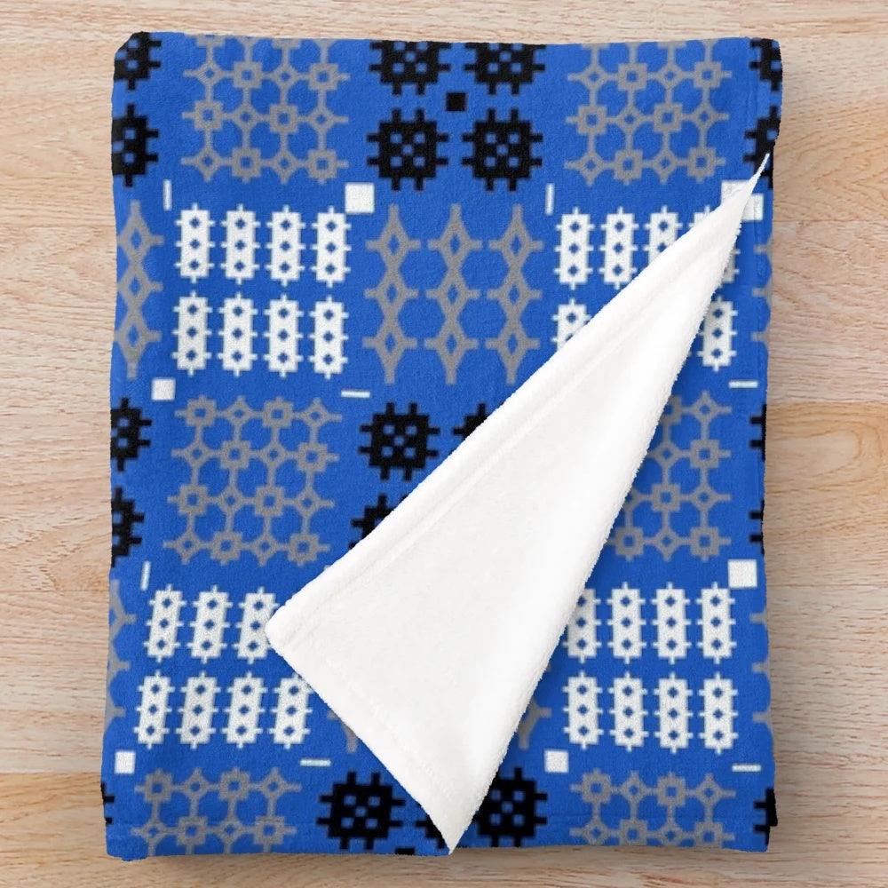 Blue Welsh tapestry pattern plush blanket with traditional Cymraeg design