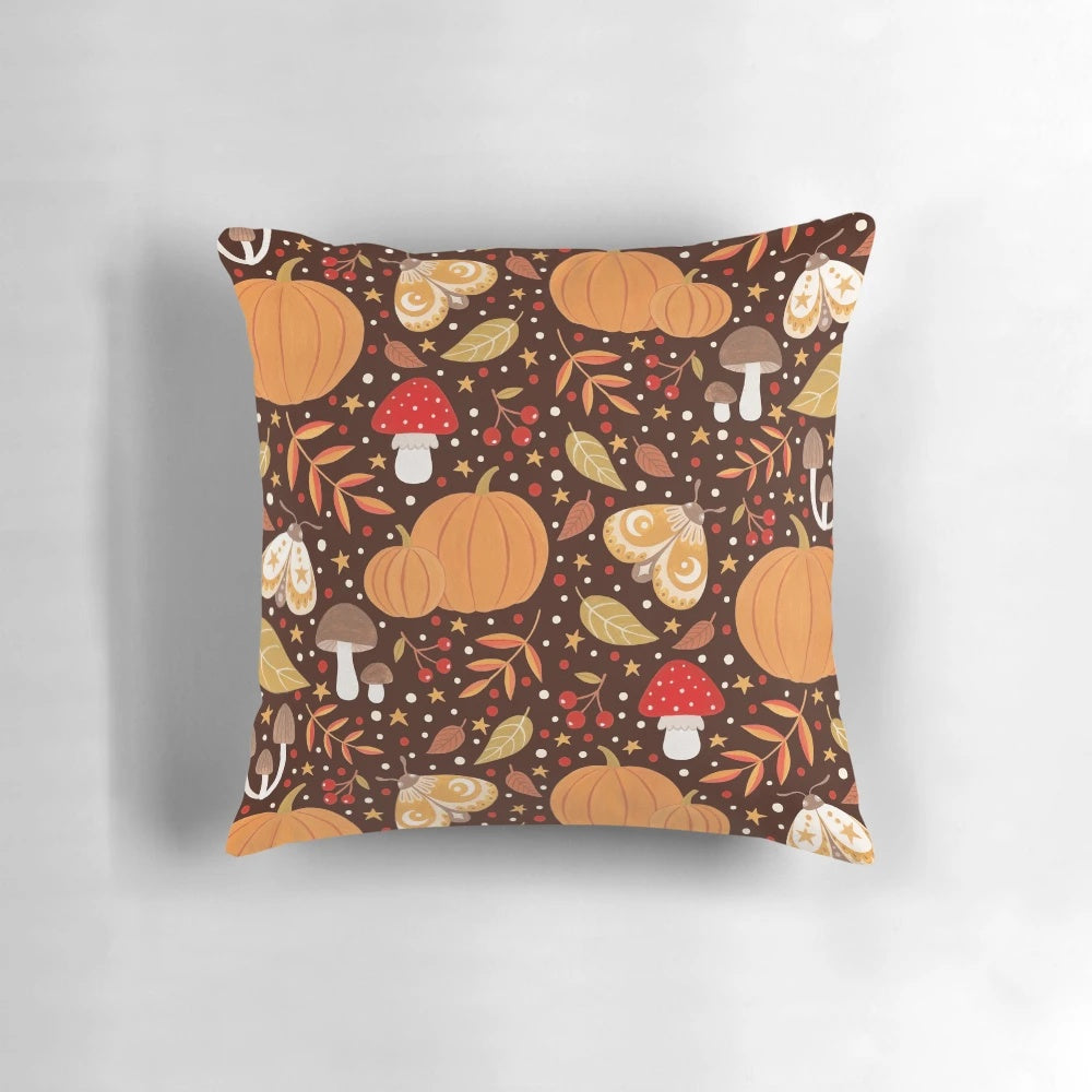 Autumn elements decorative pillow featuring a pattern with leaves, berries, pumpkins, and insects