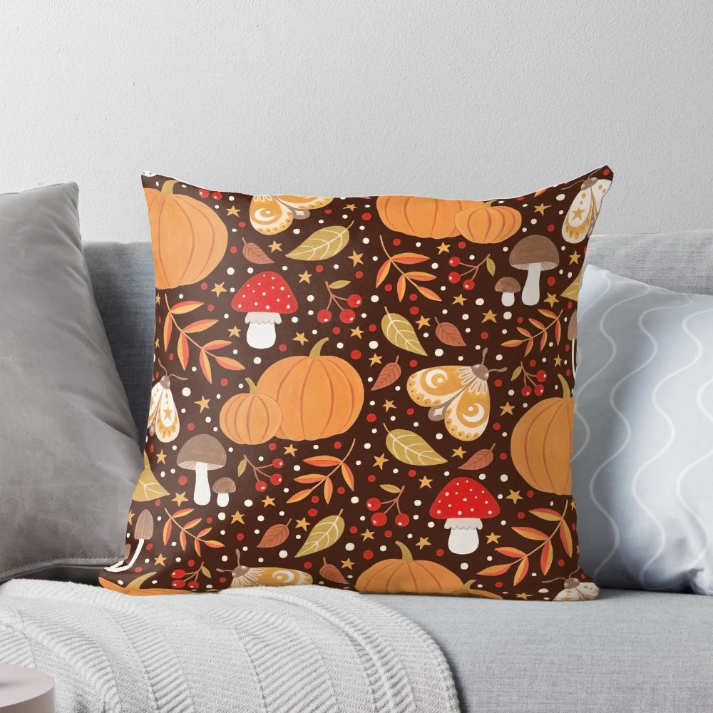 Autumn elements decorative pillow featuring a pattern with leaves, berries, pumpkins, and insects