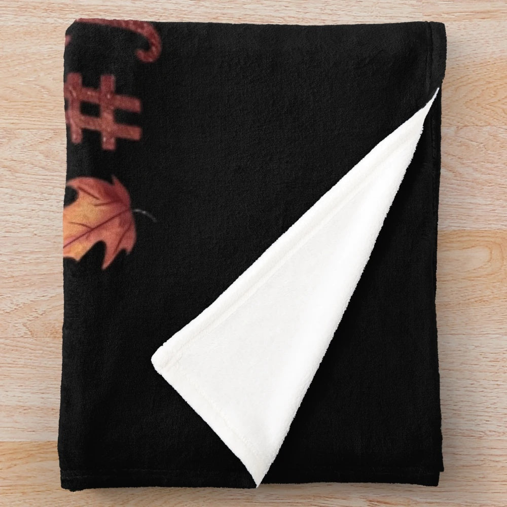 Autumn essentials plush blanket featuring fall elements like leaves, pumpkins, and warm drinks