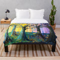 Plush blanket featuring a vibrant autumn-themed forest scene with yellow and purple leaves