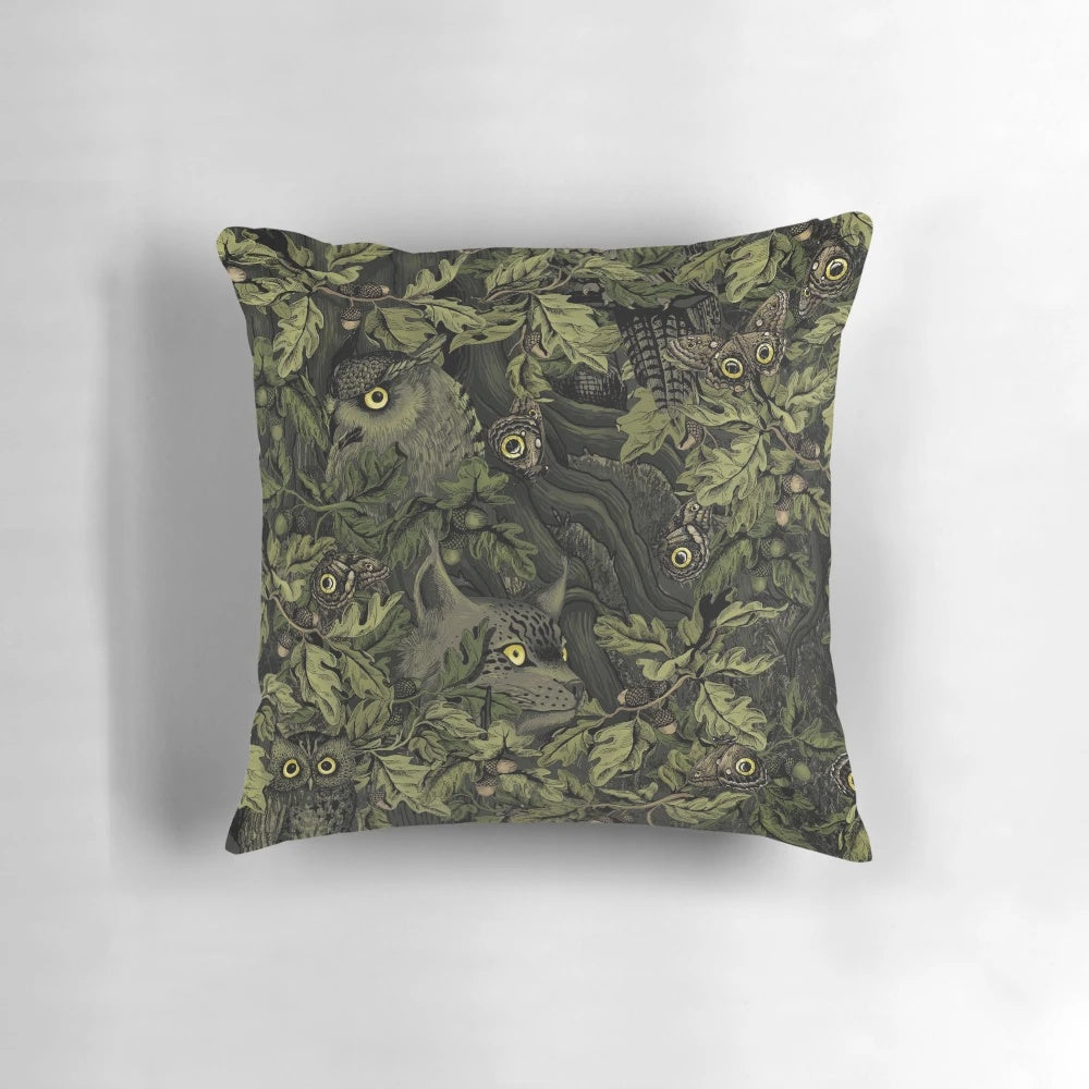 Olive green pillow with autumn leaves, oak acorns, and a camouflage pattern inspired by nature.